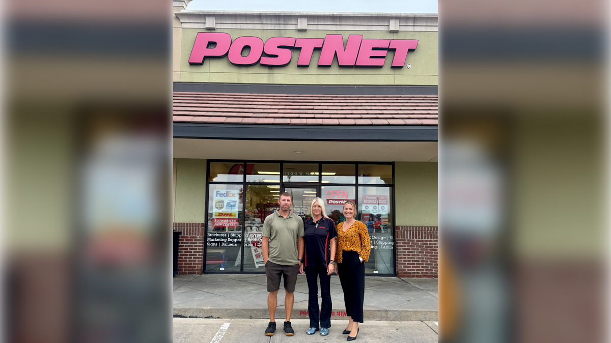 Brandt Wise, left, and his wife, Stephanie Wise, right, have purchased the west-side PostNet store, which Brandt Wise’s sister, Brandi Wise, center, will run.