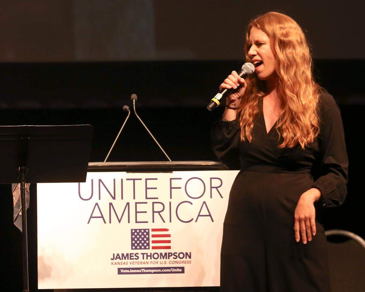 Sedgwick County Commission candidate Lacey Cruse sings in front of a crowd of around 3,000 people gathered at rally in support of Kansas congressional candidate James Thompson at Century II Convention and Performing Arts Center. Bernie Sanders and Alexandria Ocasio-Cortez were in town to endorse Thompson. (July 20, 2018)