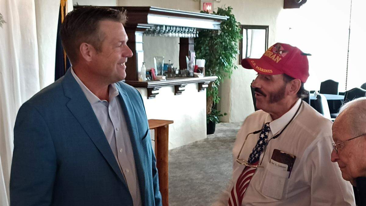 Republican candidate for Attorney General Kris Kobach speaks to Wichita anti-abortion activist Mark Gietzen at a Wichita Pachyderm Club campaign appearance. Gietzen helped fund a recount of the Value Them Both amendment in several counties, a move that ultimately failed to change the outcome of the election.