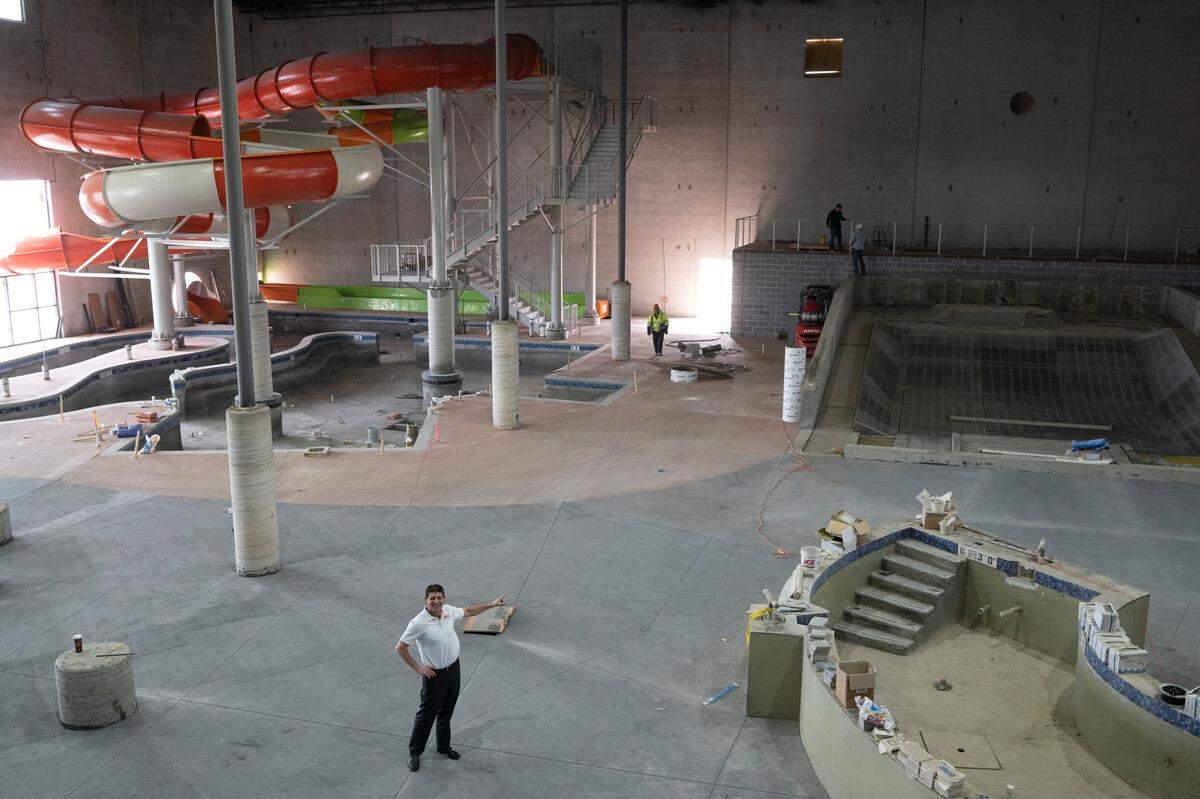 Rodney Steven II stands inside the Blast Off Bay water park at the Genesis Sports Complex in Goddard. In addition to the water park, which includes a swim-up bar and an indoor surf machine, there will be a new Genesis Health Club, a 600-seat competitive natatorium and five new softball fields to go with the existing five baseball fields. The complex also includes a 133-room Hampton Inn and a licensed preschool.