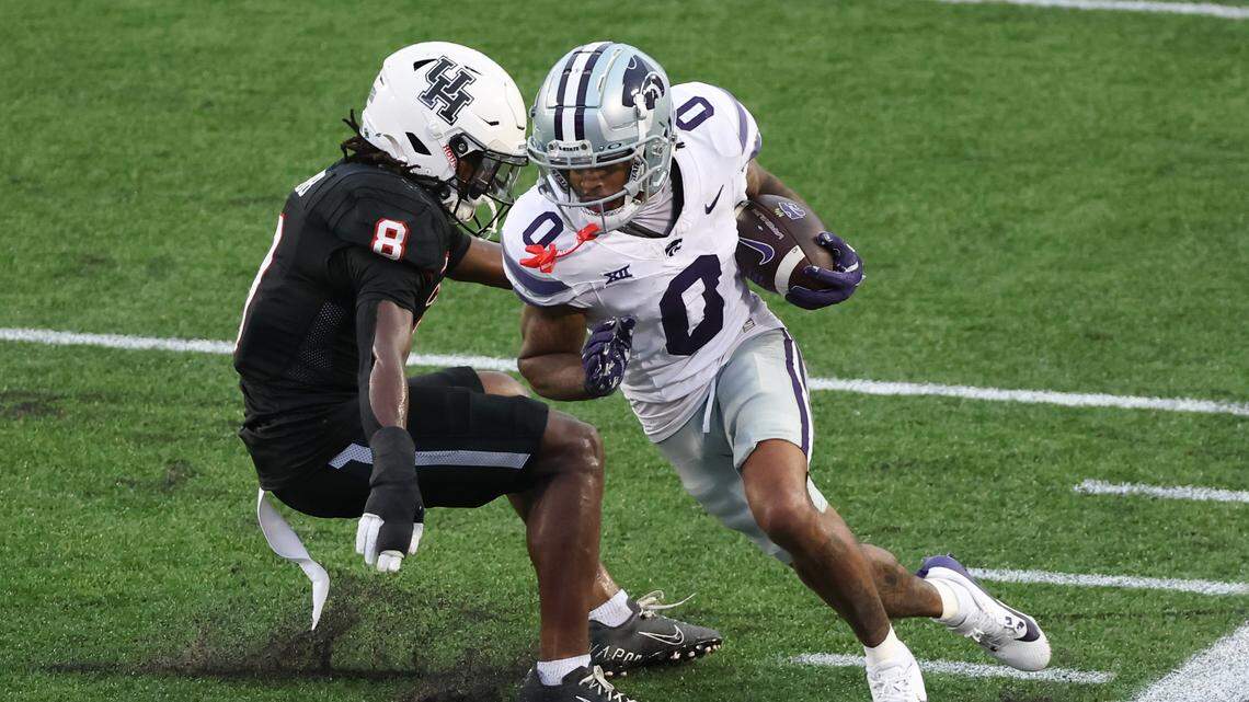 Kansas State Wildcats wide receiver Jadon Jackson (0) runs against Houston Cougars defensive back Kentrell Webb (8) after a catch in the second quarter at TDECU Stadium.