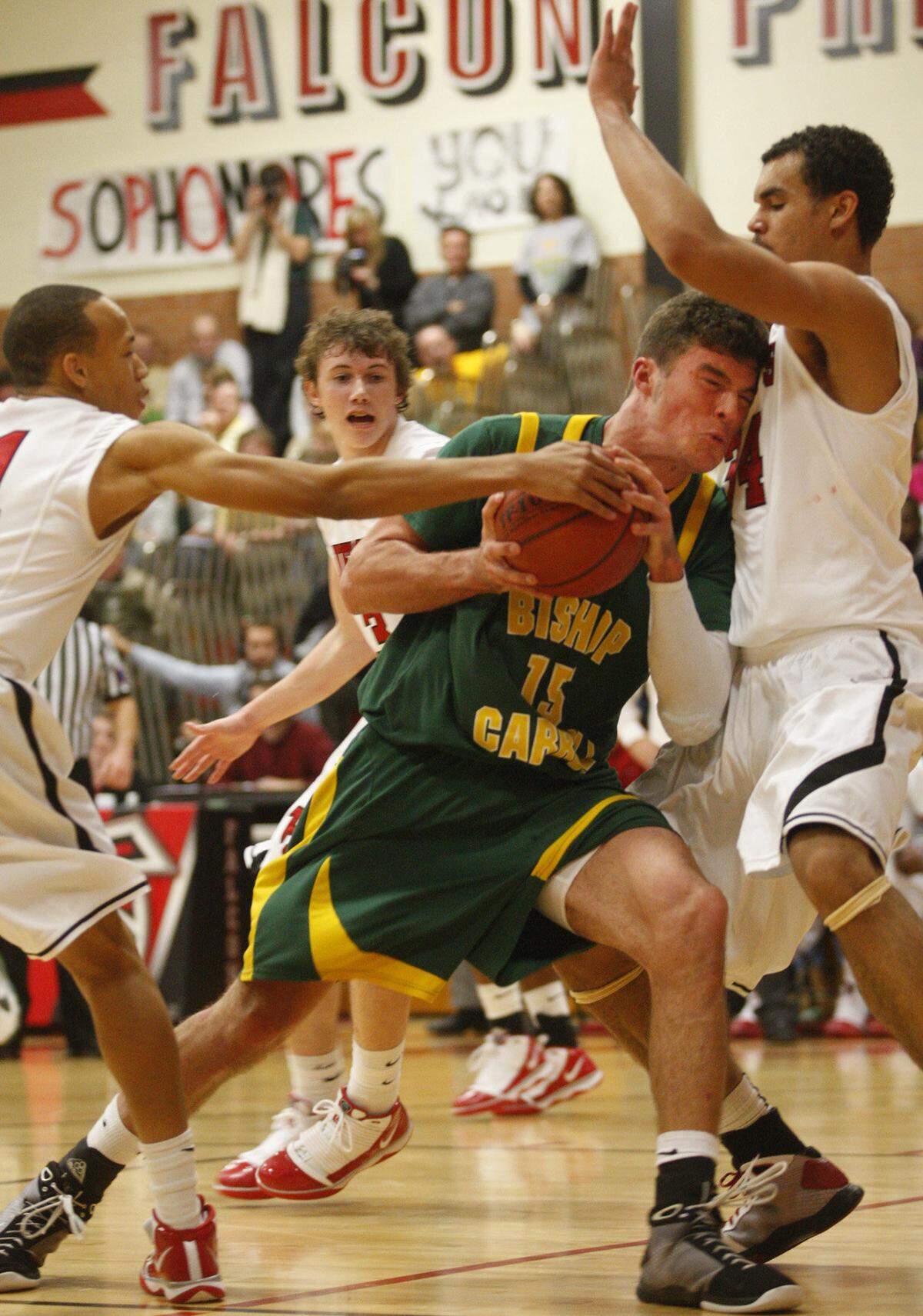 Bishop Carroll’s Blake Bell runs into Heights’ Perry Ellis as he drives the lane in the 2nd half on Tiuesday, Jan. 12, 2010 at Heights High.