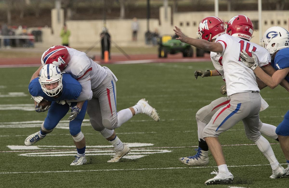 Adam Walock #4 of Goddard was tackled by Dylan Downing #33 of Bishop Miege in the Kansas Class 4a championship Saturday, November 24, 2018 at Topeka Hummer complex. Bishop Miege won the championship 69-31
