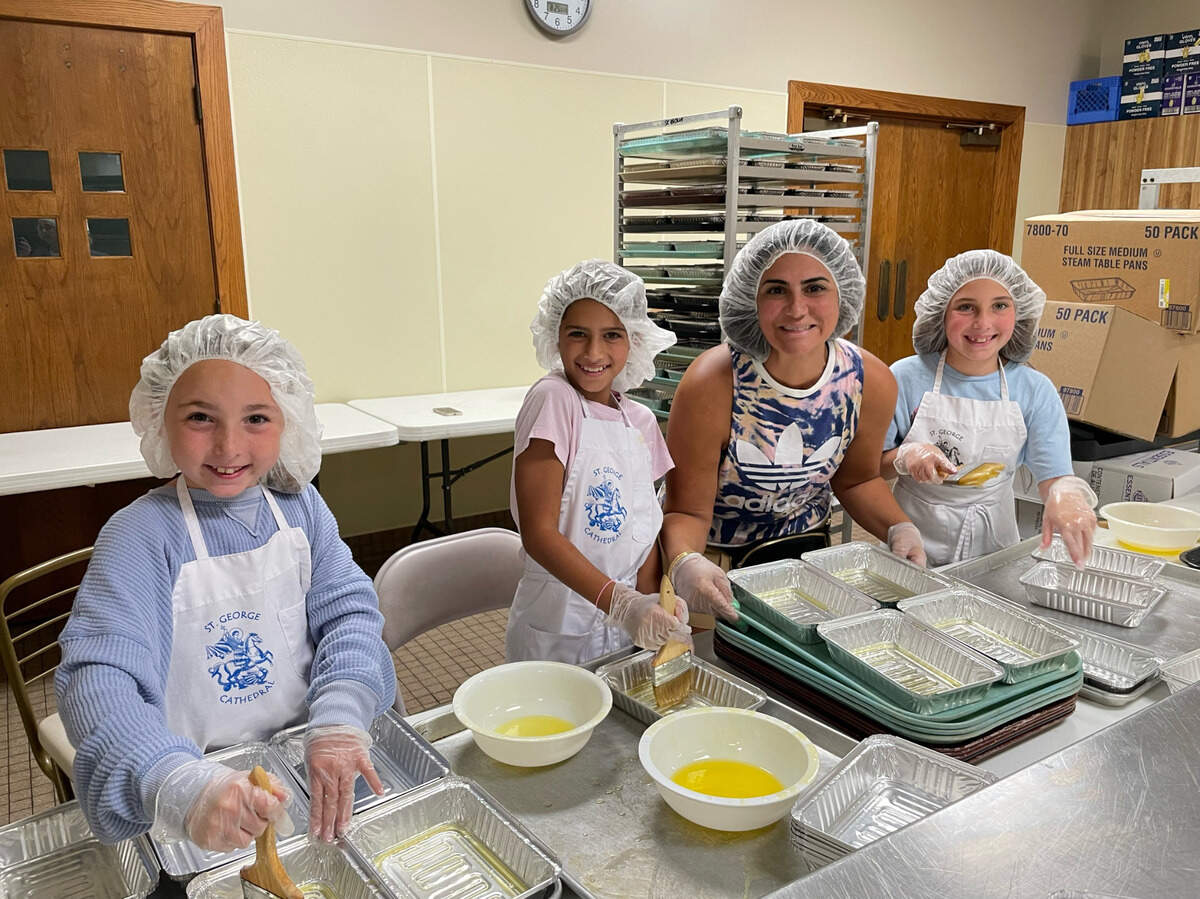 Lebanese dinner co-chair Alexis Phillips, third from left, helps train younger members of the congregation.