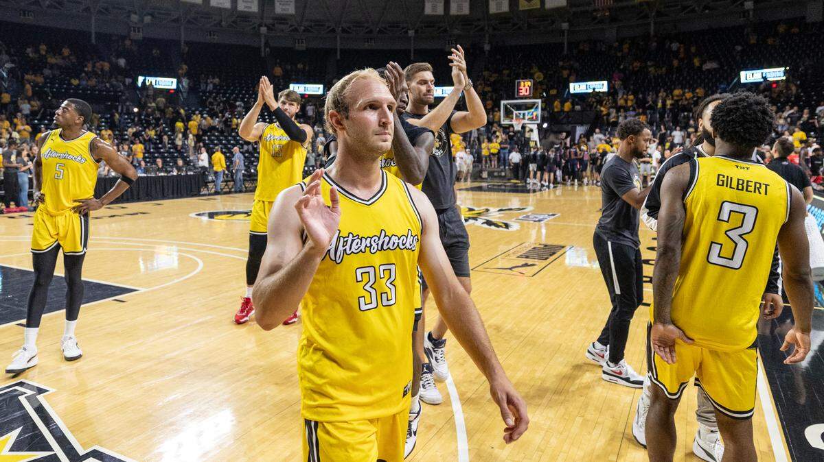Members of the AfterShocks wave to the crowd as they leave the court after a 23 point loss to Team Heartfire on Tuesday night. A TBT record crowd was on hand to see the final game of the Wichita region.
