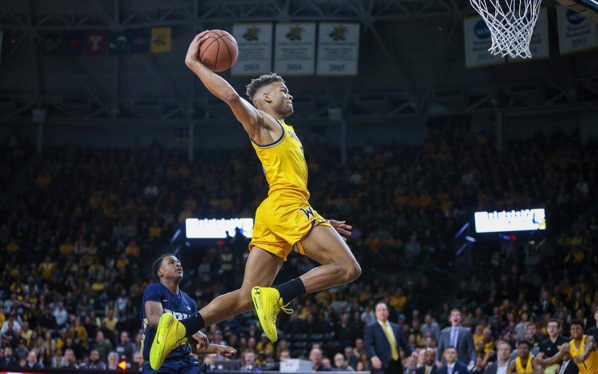 Wichita State’s Dexter Dennis dunks the ball against Oral Roberts during a game in 2019. Dennis and his teammates are hoping to replicate the success of the Shocker teams before them as they make their first appearance in the NCAA Tournament Thursday against Drake.