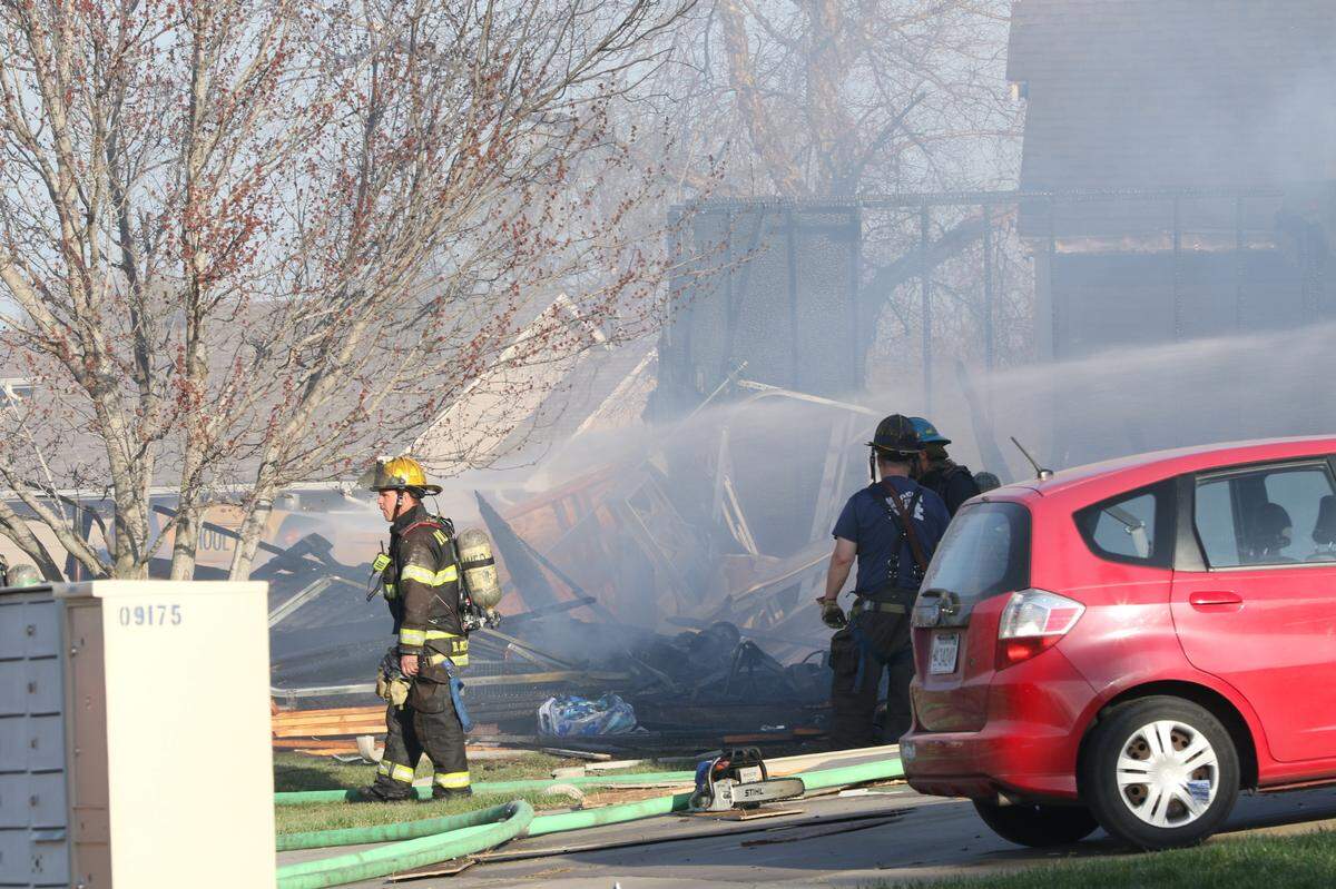 Wichita firefighters put out flames after an explosion at a southwest Wichita home Sunday evening. 