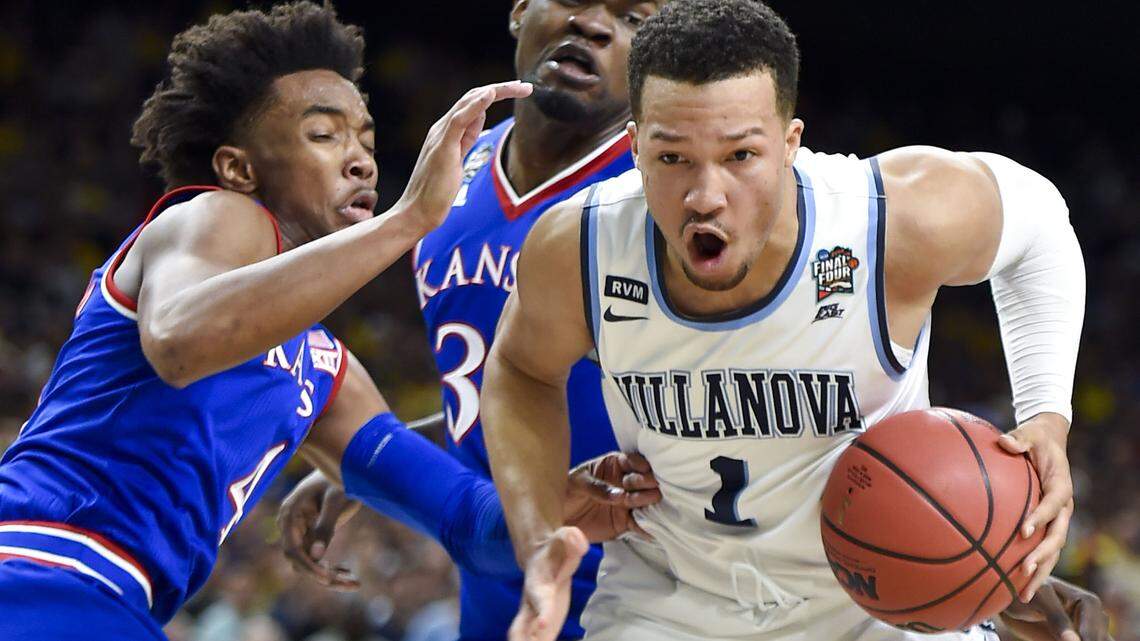 Villanova’s Jalen Brunson (1) gets by Kansas’ Devonte’ Graham (4) and Udoka Azubuike (35) during an NCAA Tournament national semifinal on Saturday, March 31, 2018, at the Alamodome in San Antonio, Texas. (Rich Sugg/Kansas City Star/TNS)