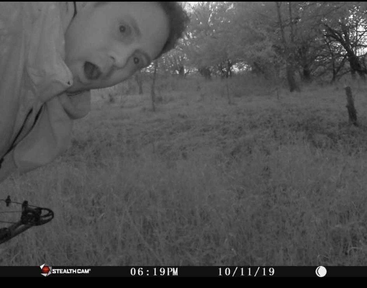 Brian Butcher of Andover gets down from his stand and makes a suprised face at his trail cam after shooting the largest buck in Kansas history and the second in the U.S.