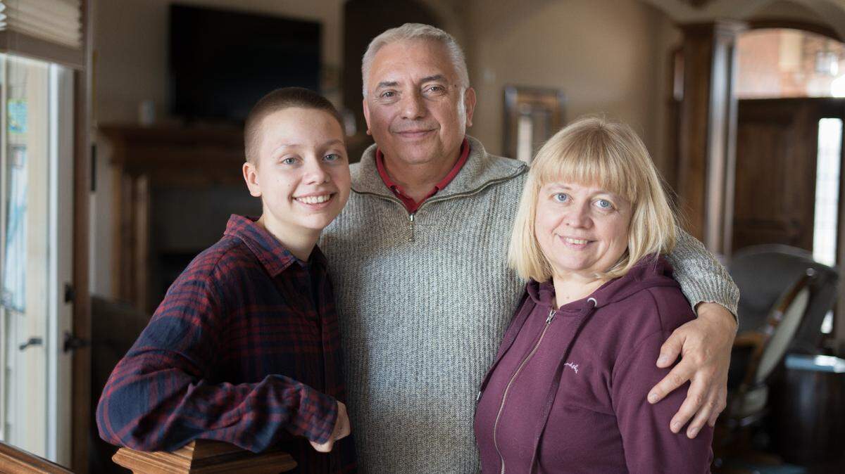 Fleeing the Russian invasion of their homeland, Ukrainian refugees Volodymyr Plegutsa, center, his wife, Victoria, right, and daughter, Xenia, have settled into a house in south Wichita for the two years they can stay under the federal program Uniting for Ukraine.