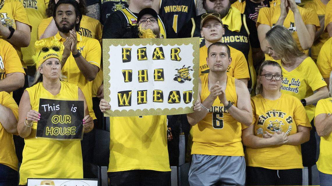Heather Marsh, Kyle Coffman (behind the sign), and Steven and Hayley Harris waited for hours outside Koch Arena Sunday to get front-row seats for the AfterShocks championship game.