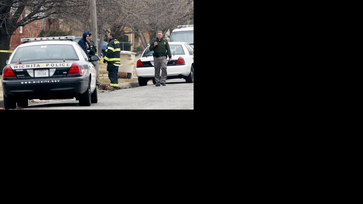 Police officers investigate a shooting in the 2300 block of West Graber. (Feb. 25, 2014)

