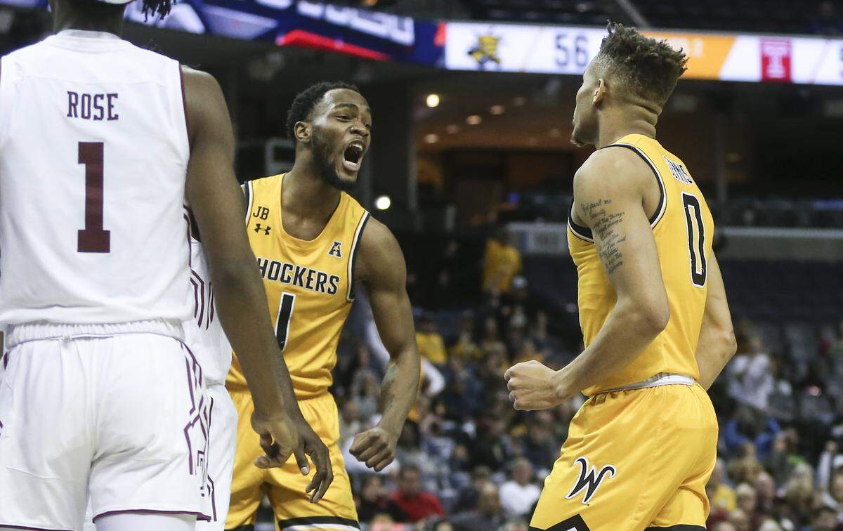 Wichita State forward Markis McDuffie reacts with teammate Dexter Dennis after Dennis scored a basket and was fouled during the second half of their American Athletic Conference quarterfinal game against Temple in Memphis on Friday.