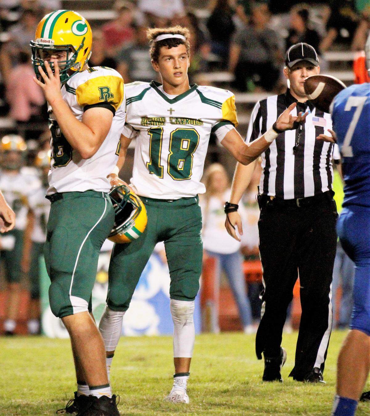 Aiden Niedens, Bishop Carroll sophomore quarterback, recovers after getting his helmet knocked off during the Golden Eagles’ 28-14 win at Kapaun on Friday. (Oct. 5, 2018)