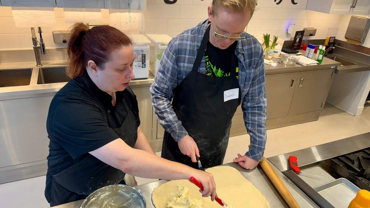 Chef Bethany Annuschat, left, leads Daniel DeGroot though a croissant-making class at Sur La Table in Bradley Fair.