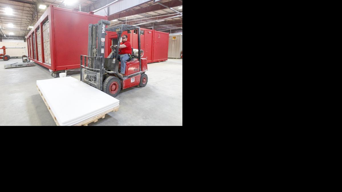 A shop technician moves some fiberglass reinforced panels to be put into a Red Guard building at its factory in south Wichita. The company makes pre-fabricated, blast-resistant housing and offices for refineries and chemical plants in Canada as well as the U.S. and other countries. (Feb. 11, 2014)

