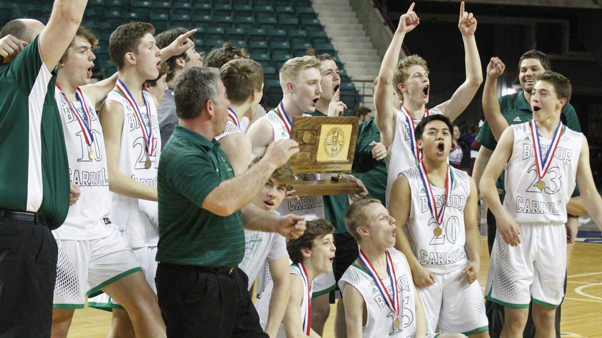 The Bishop Carroll boys basketball team celebrates its first state championship in school history. The Golden Eagles beat Salina Central 43-41 in overtime in the Class 5A final Saturday, March 10, 2018, at the Kansas Expocentre in Topeka.