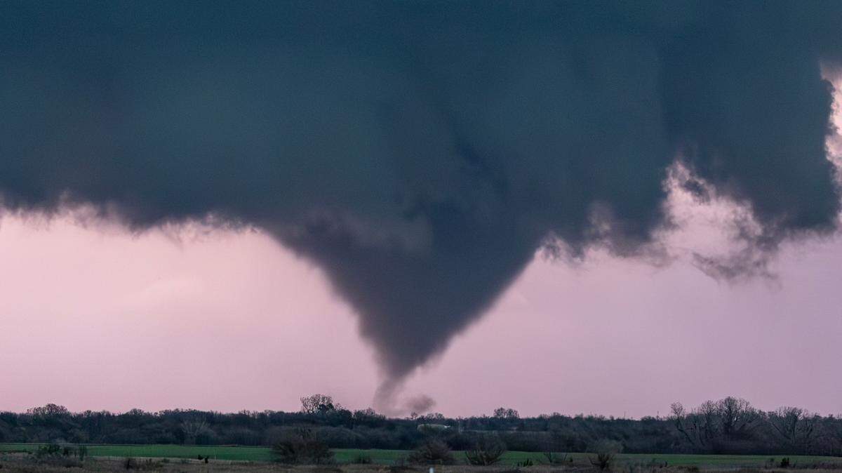A tornado, illuminated by lightning, forms near Alta Vista on Wednesday night just after sunset. The storm mostly stayed over open country.
