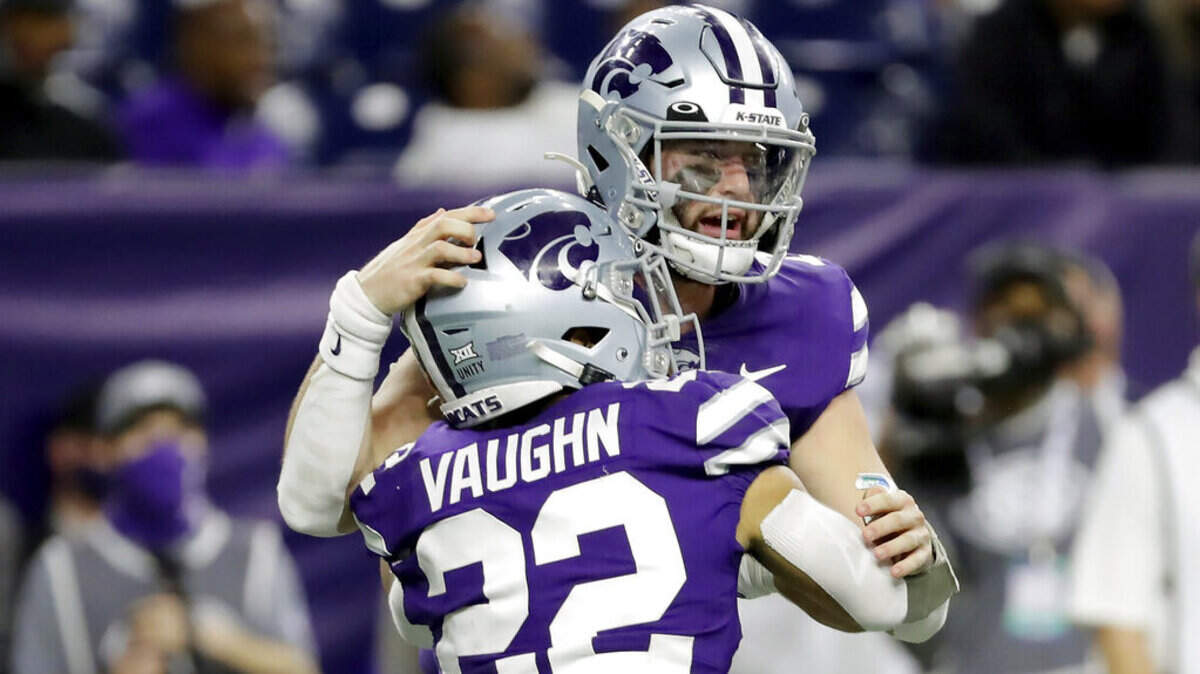 Kansas State running back Deuce Vaughn (22) and quarterback Skylar Thompson celebrate a touchdown by Vaughn during the second half of the team’s Texas Bowl NCAA college football game against LSU on Tuesday, Jan. 4, 2022, in Houston. (AP Photo/Michael Wyke)