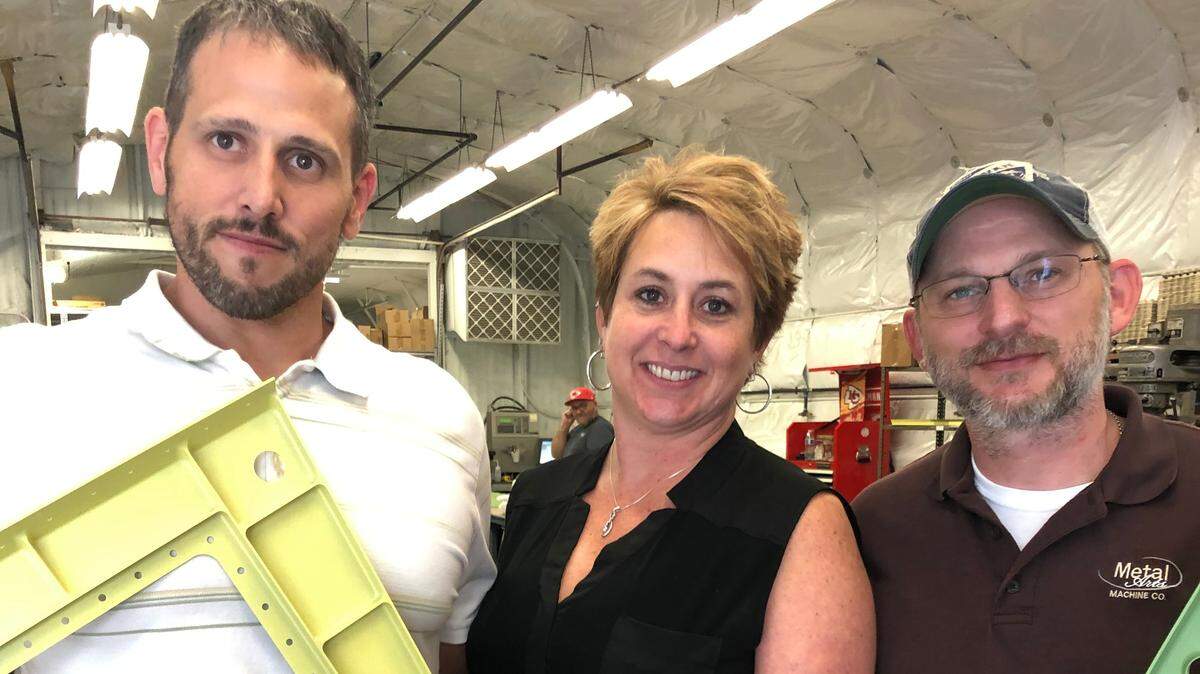 Dustin Gray, Charlotte Anderson and Tony Poell with some aircraft parts made by Metal Arts Machine Co. 