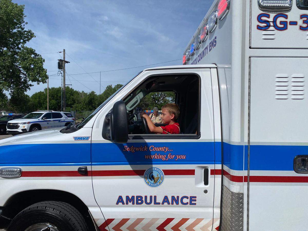 A camper enjoys sitting in the drivers seat of an ambulance vehicle at the Boy Scout Awareness Camp on June 3, 2022 at OJ Watson Park. At the camp, campers enjoyed a day of fun activities with their camp counselors. On the next day, those counselors were revealed to be first responders. The purpose is to build relationships between the next generation and first responders.