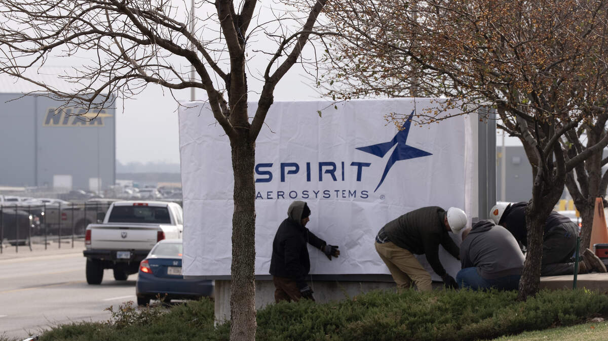 A cover is placed over a Boeing sign that was installed in front of the main administration building at Spirit.