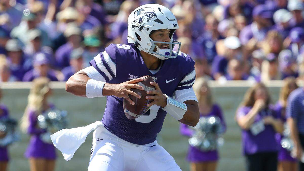 Kansas State Wildcats quarterback Adrian Martinez (9) looks for room to run during the first quarter against the Tulane Green Wave at Bill Snyder Family Football Stadium.
