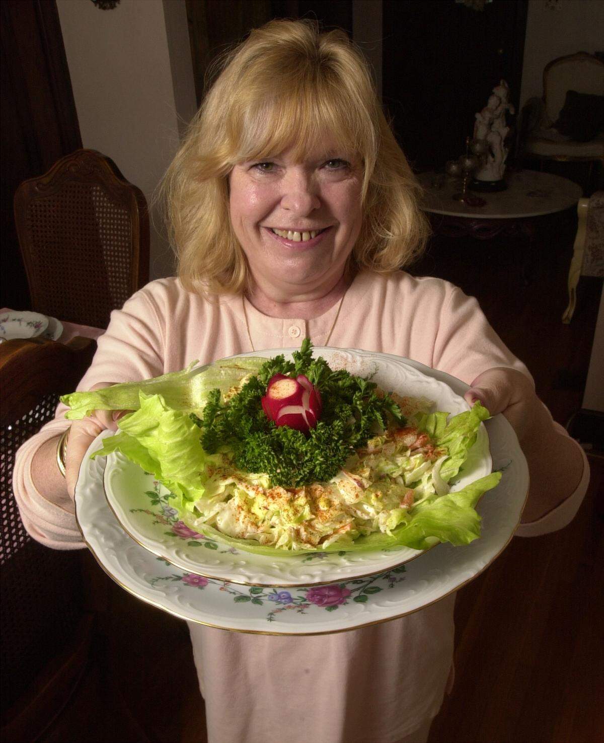 Suzy Hill holds a garlic salad just like the one served in her father’s north Wichita restaurant in the 1940s.  Her father, Ken Hill, started Ken’s Klub on West 29th Street in 1946.