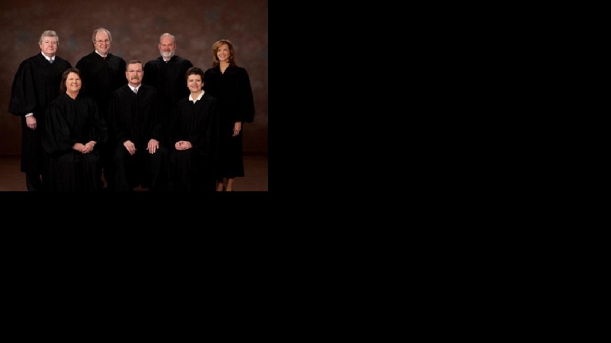 The Kansas Supreme Court. Seated, from left: Justice Marla Luckert, Chief Justice Lawton Nuss and Justice Carol Beier. Standing, from left: Justice Dan Biles, Justice Eric Rosen, Justice Lee Johnson and Justice Nancy Moritz.