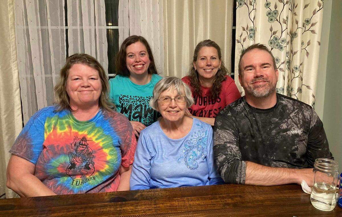 Stephanie Purcell (front left) poses for a photo with her three siblings and their mother.