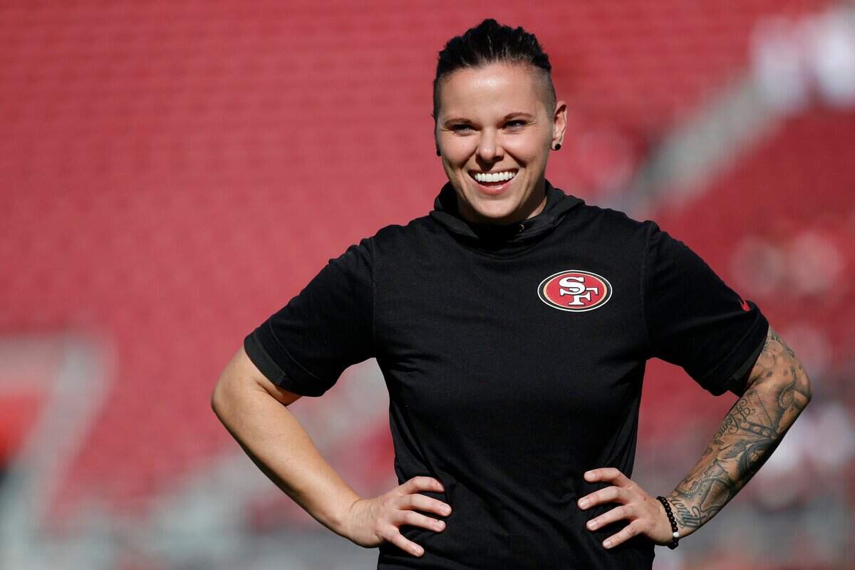 San Francisco 49ers offensive assistant Katie Sowers watches warms up before an NFL football game against the Arizona Cardinals in Santa Clara, Calif., Sunday, Nov. 17, 2019.