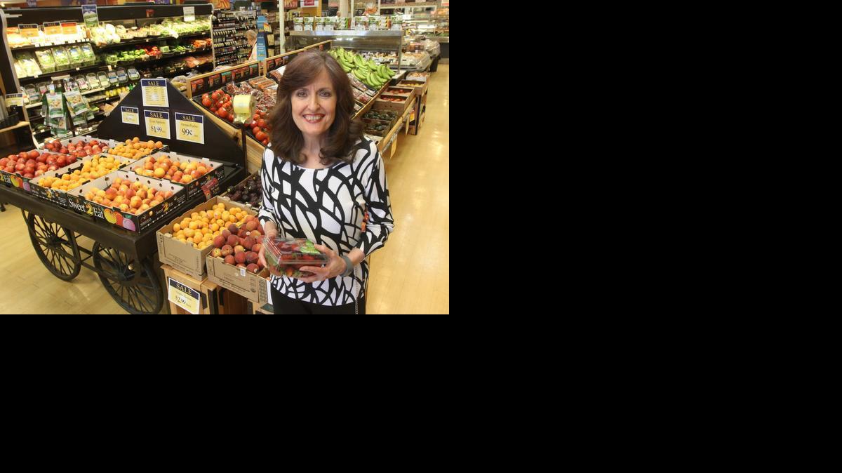 Barb Hoffmann, co-founder of GreenAcres Market, stands in the fresh fruit and vegetable section of her store in Bradley Fair. (July 1, 2014) 

