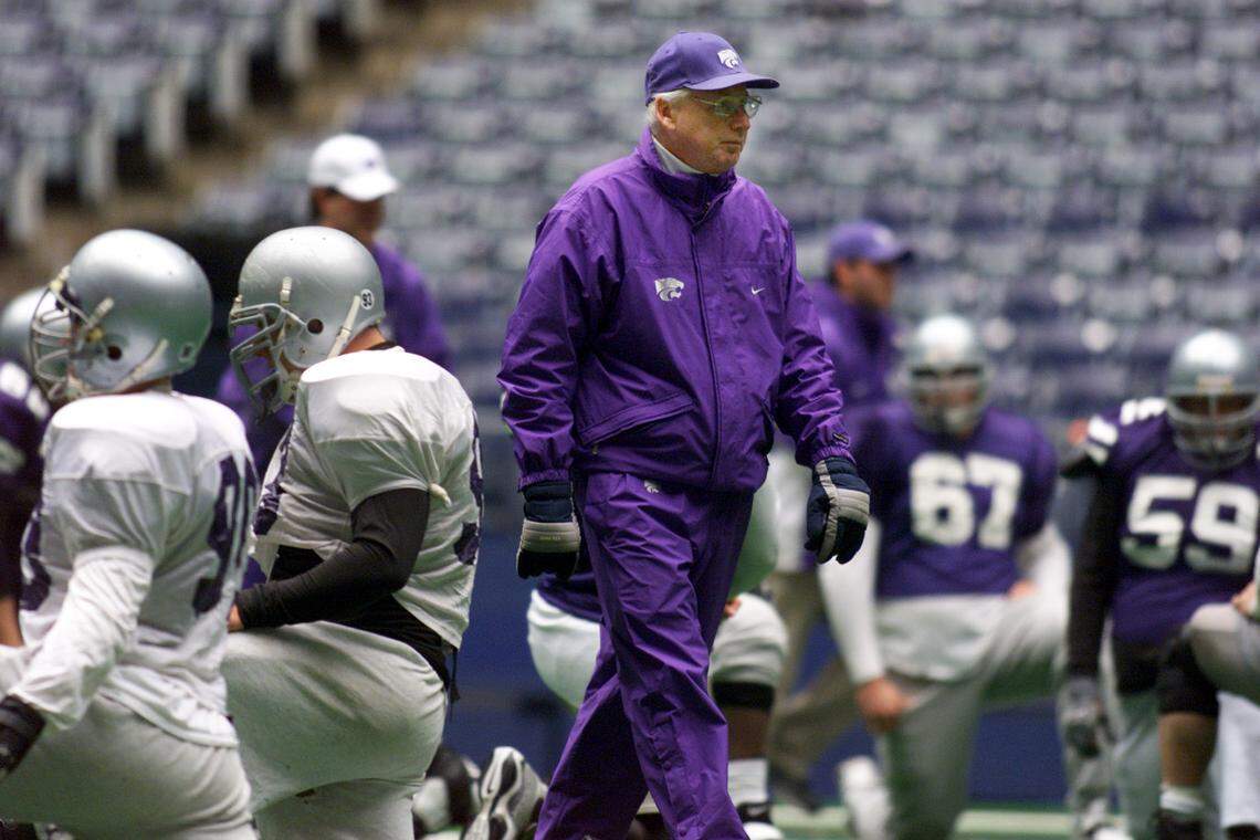 Kansas State coach Bill Snyder walks among players as they stretch during pratice at Texas Stadium in Irving, Texas, Wednesday, Dec. 27, 2000. Kansas will face Tennessee in the Cotton Bowl in Dallas on New Year’s Day. (AP Photo/Donna McWilliam)