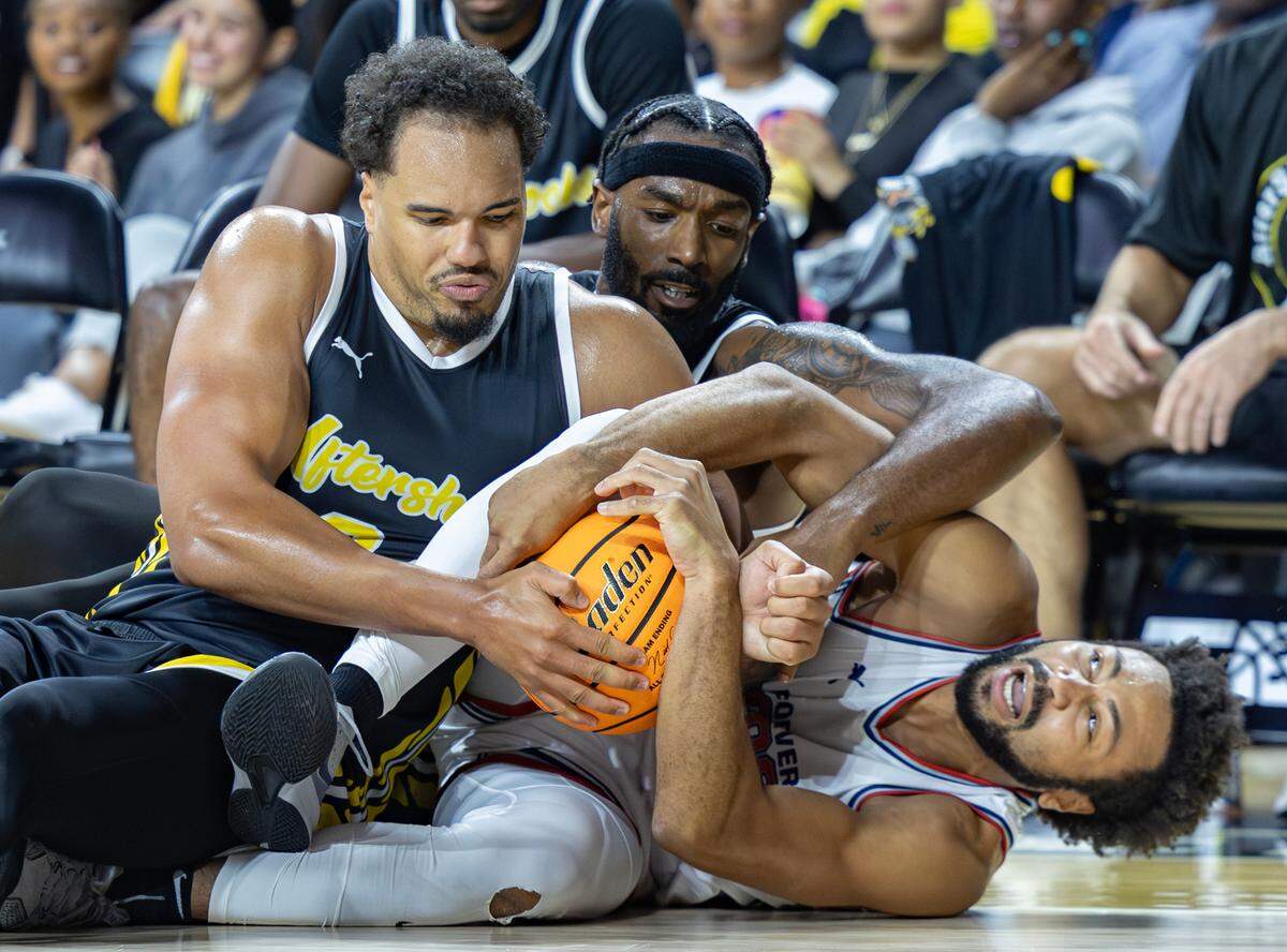 Marcus Santos Silva, left, and Rashard Kelly, middle, get tied up with Galen Robinson of the Forever Coogs during the second half.