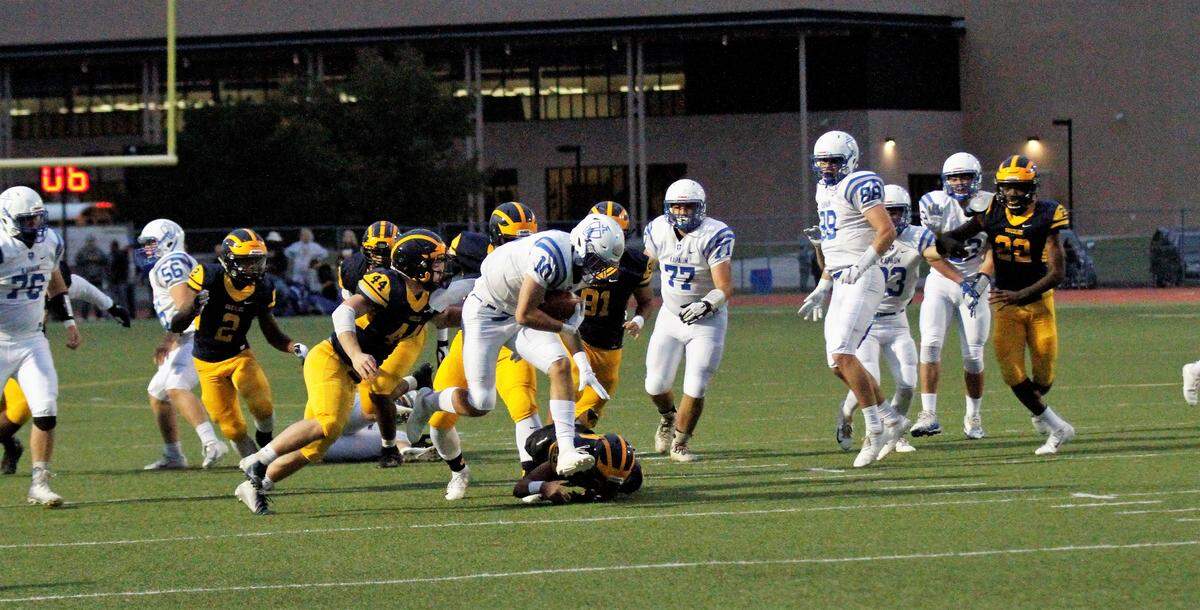 Kapaun’s Scott Valentas fights for extra yardage during the Crusaders’ 55-26 loss to Wichita Northwest on Friday. (Sept. 28, 2018)
