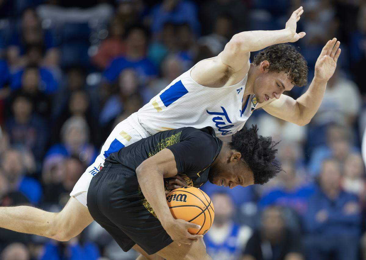 Wichita State’s Kenyon Giles is fouled by Miles Barnstable during the second half of their NIT quarterfinal game in Tulsa on Tuesday.