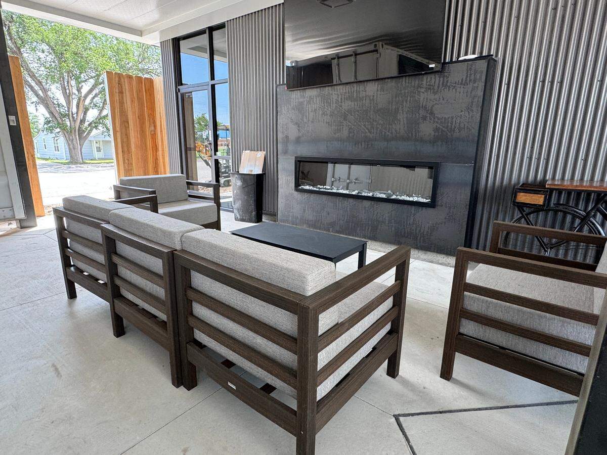Point Nine in Andover features a large, covered patio with big booths, tables and chairs and a seating area near an outdoor fire place.