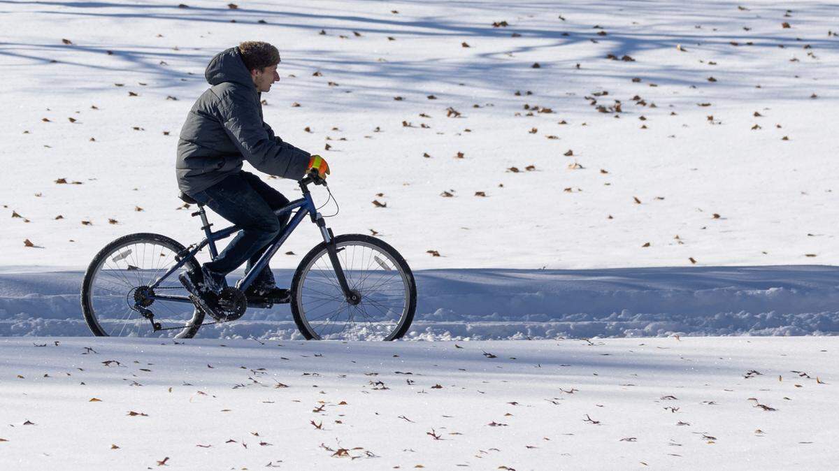 A bicyclist makes his way through North Riverside Park on Sunday, the morning after 7.8 inches of snow fell in the Wichita area. 