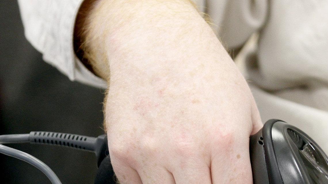 Link Herrman scans a voter's ID at the Sedgwick County Zoo Cargill Learning Center precinct. Voters are casting ballots under the stateÕs new voter photo identification law. (February 28, 2012)




