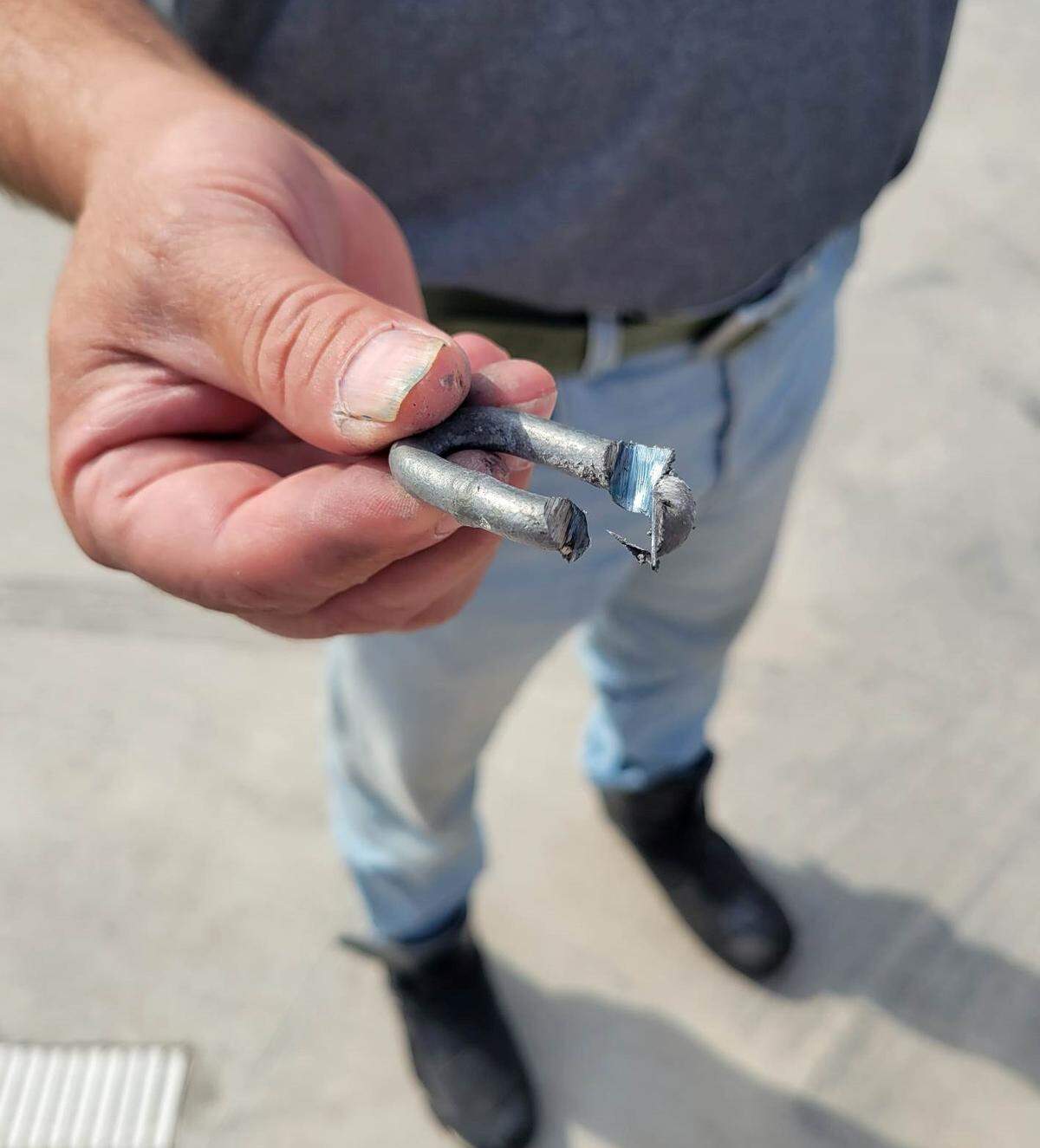 Wichita Parks and Recreation Director Troy Houtman holds a piece of a chain that was cut with a grinder early Wednesday morning at Aley Pool.