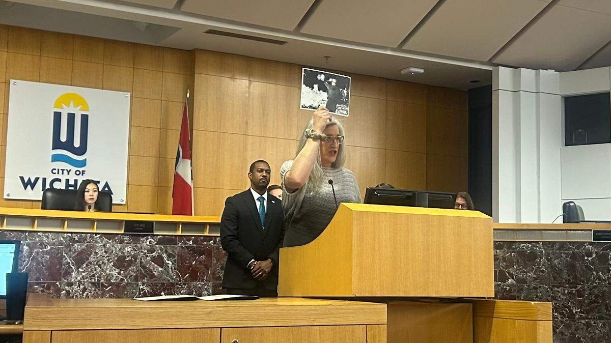Abi Boatman, a transgender military veteran, accepted the proclamation for Transgender Day of Visibility at Tuesday’s Wichita City Council meeting and held up a picture of a Nazi book burning.
