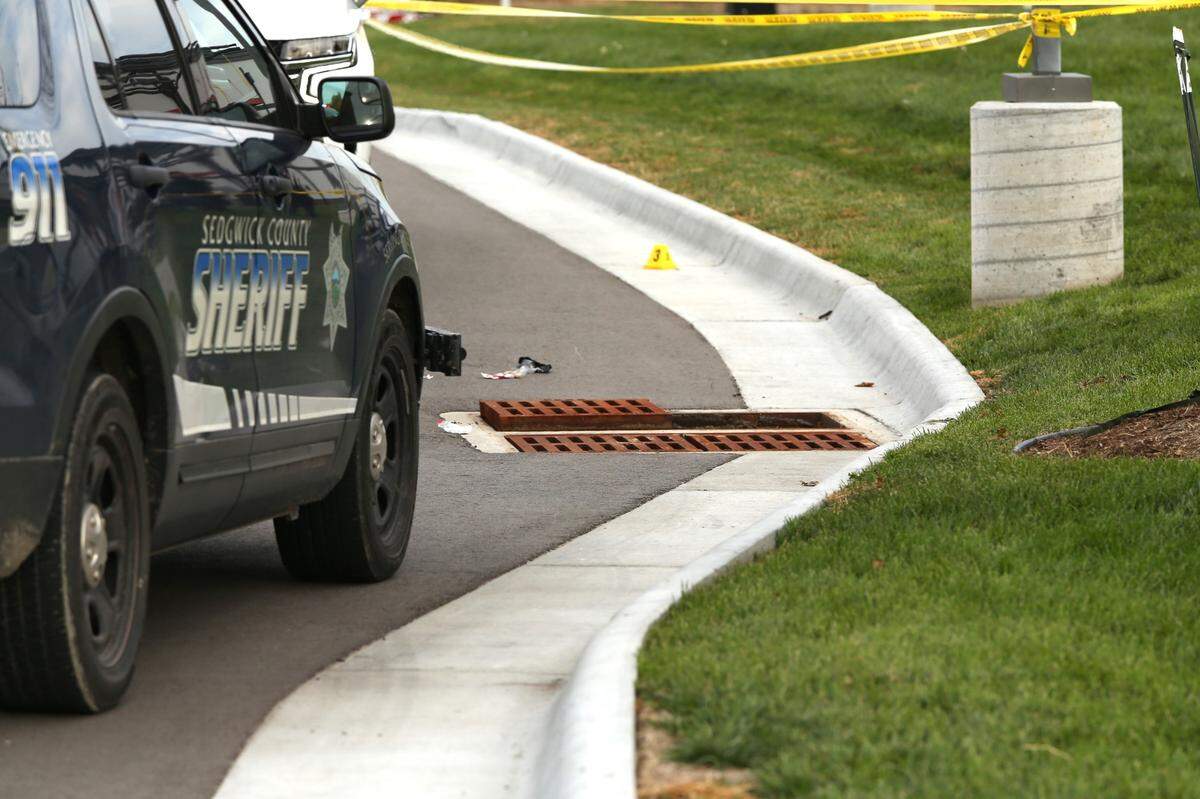 Authorities had the area between Take 5 Oil Change and the Club Car Wash on Maize Road blocked off where they said the suspect climbed down into the sewer drain shown in the photo.