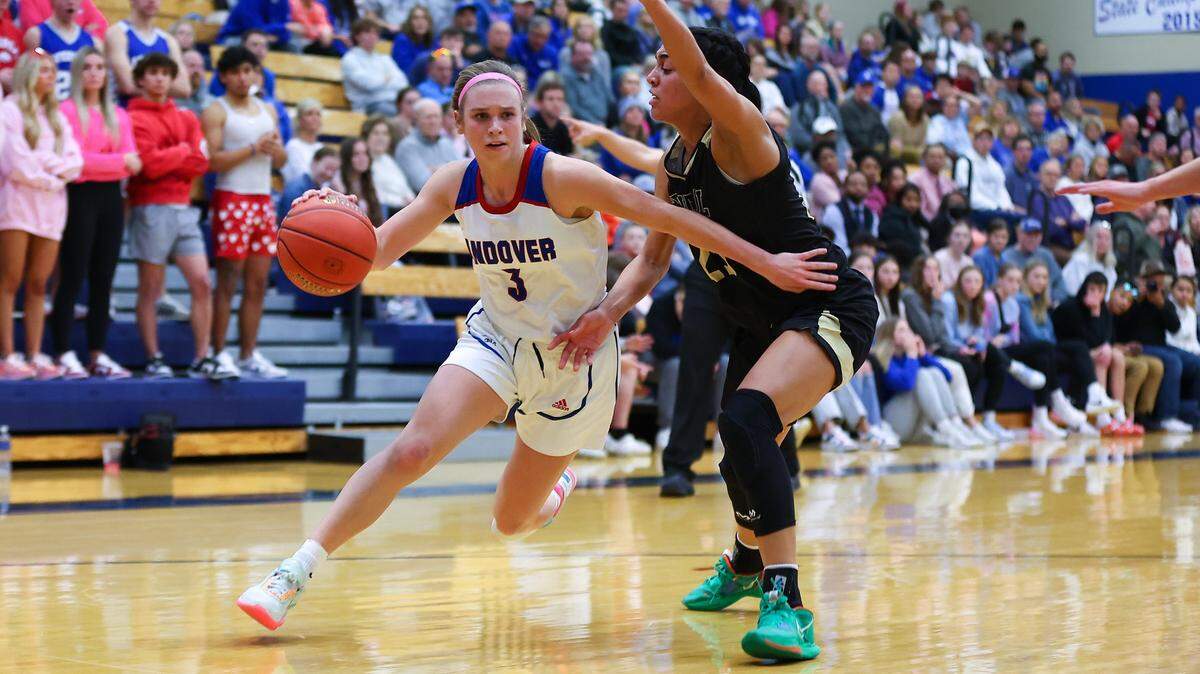 Andover’s Brooke Walker drives to the basket against Andover Central’s Maddie Amekporfor in the Trojans’ win in the rivalry game on Tuesday.