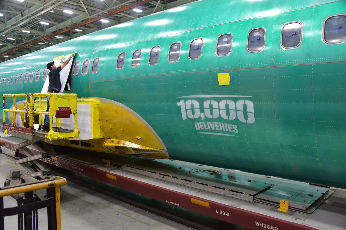 A Spirit AeroSystems worker prepares a Boeing 737 fuselage to be shipped to Washington. Business leaders and experts argue that diversifying Wichita’s economy, so that it’s not so hurt by aviation during a downturn, would benefit the city. But what does that look like, and how could it impact workers?