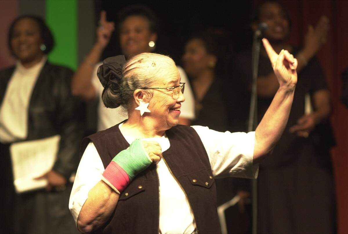 Jo Brown directs the ARISE musical group in 2003. She helped form the African Americans Renewing Interest in Spirituals Ensemble to help preserve African spiritual songs.