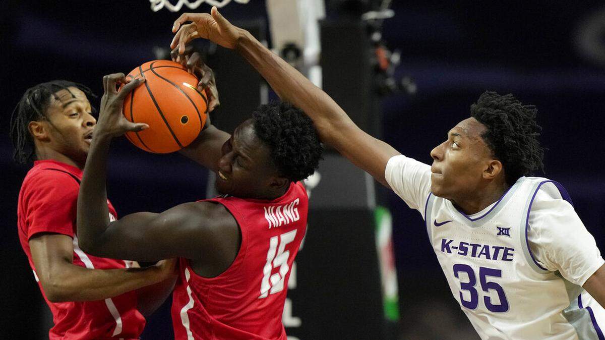 Kansas State forward Nae’Qwan Tomlin (35) tries to steal the ball from Radford forward Madiaw Niang (15) during the first half of an NCAA college basketball game Wednesday, Dec. 21, 2022, in Manhattan, Kan. (AP Photo/Charlie Riedel)
