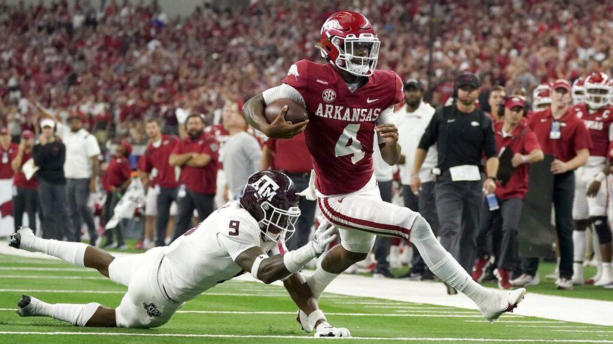 Texas A&M defensive back Leon O’Neal Jr. (9) attempts to stop Arkansas quarterback Malik Hornsby (4) as he gains yards on a run during an NCAA college football game in Arlington, Texas, Saturday, Sept. 25, 2021. (AP Photo/Tony Gutierrez)