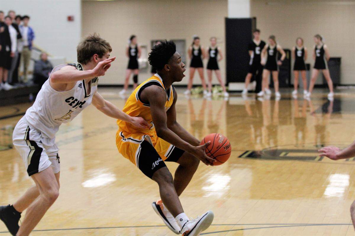 Wichita Southeast sophomore Jackie Johnson III flips a pass to a teammate during the Golden Buffaloes 82-72 overtime win over Andover Central on day one of the AVCTL/GWAL Challenge. (Jan. 10, 2019)
