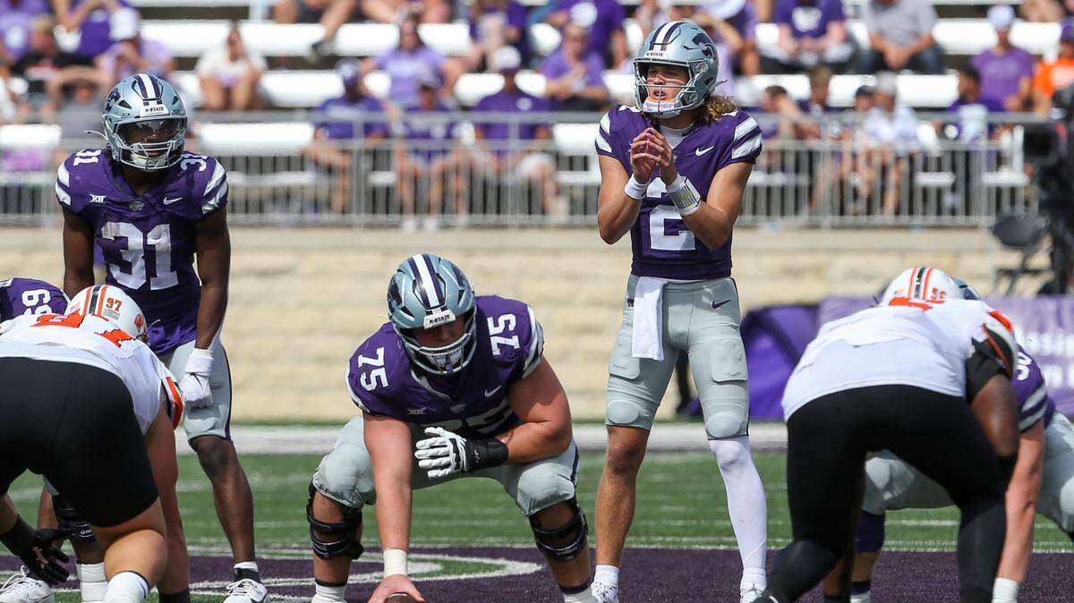 Kansas State Wildcats quarterback Avery Johnson (2) waits for the snap from center Sam Hecht (75) against the Oklahoma State Cowboys during the fourth quarter at Bill Snyder Family Football Stadium.