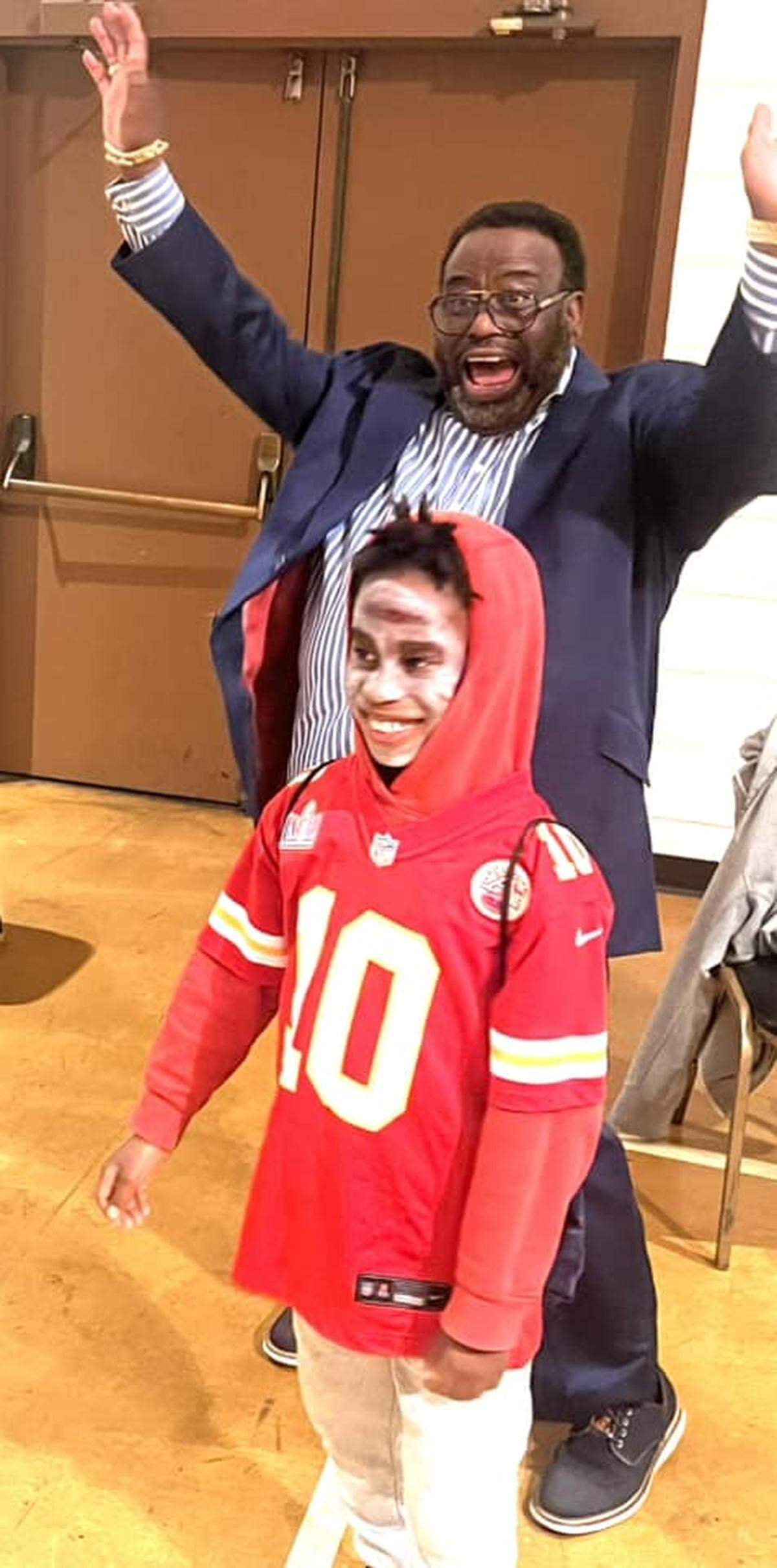 Bishop Mark Gilkey and a young friend celebrating a Super Bowl.